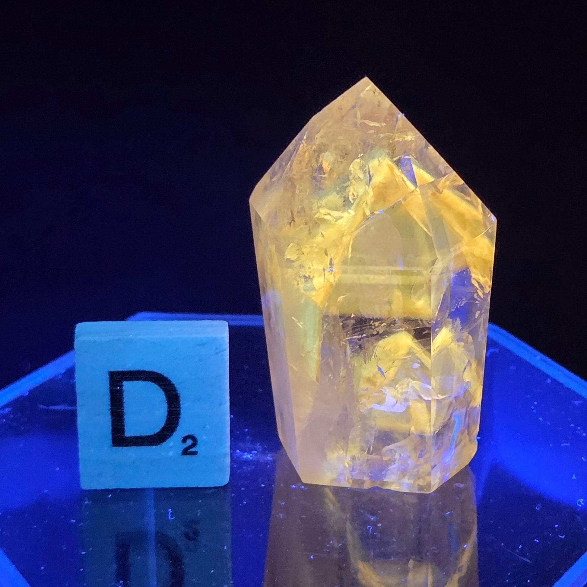 Clear crystal with a blue light on a black background
