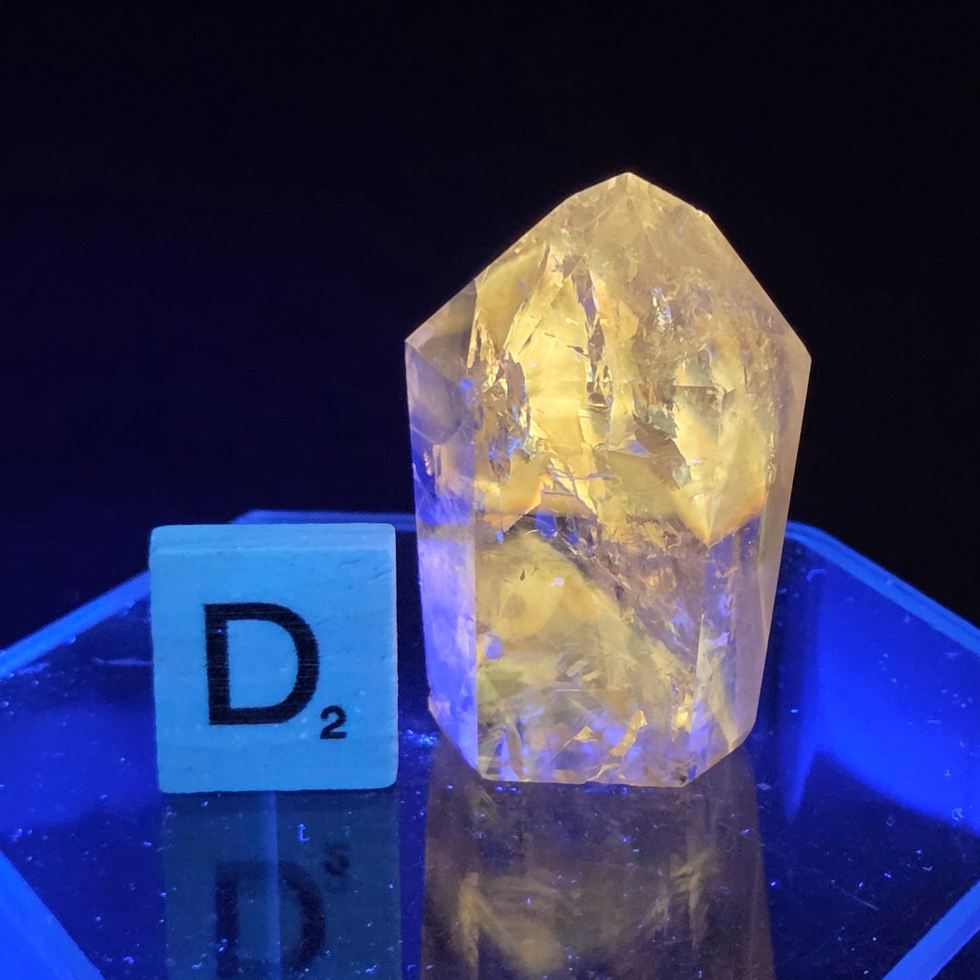 Clear crystal with a yellow tint on a black background