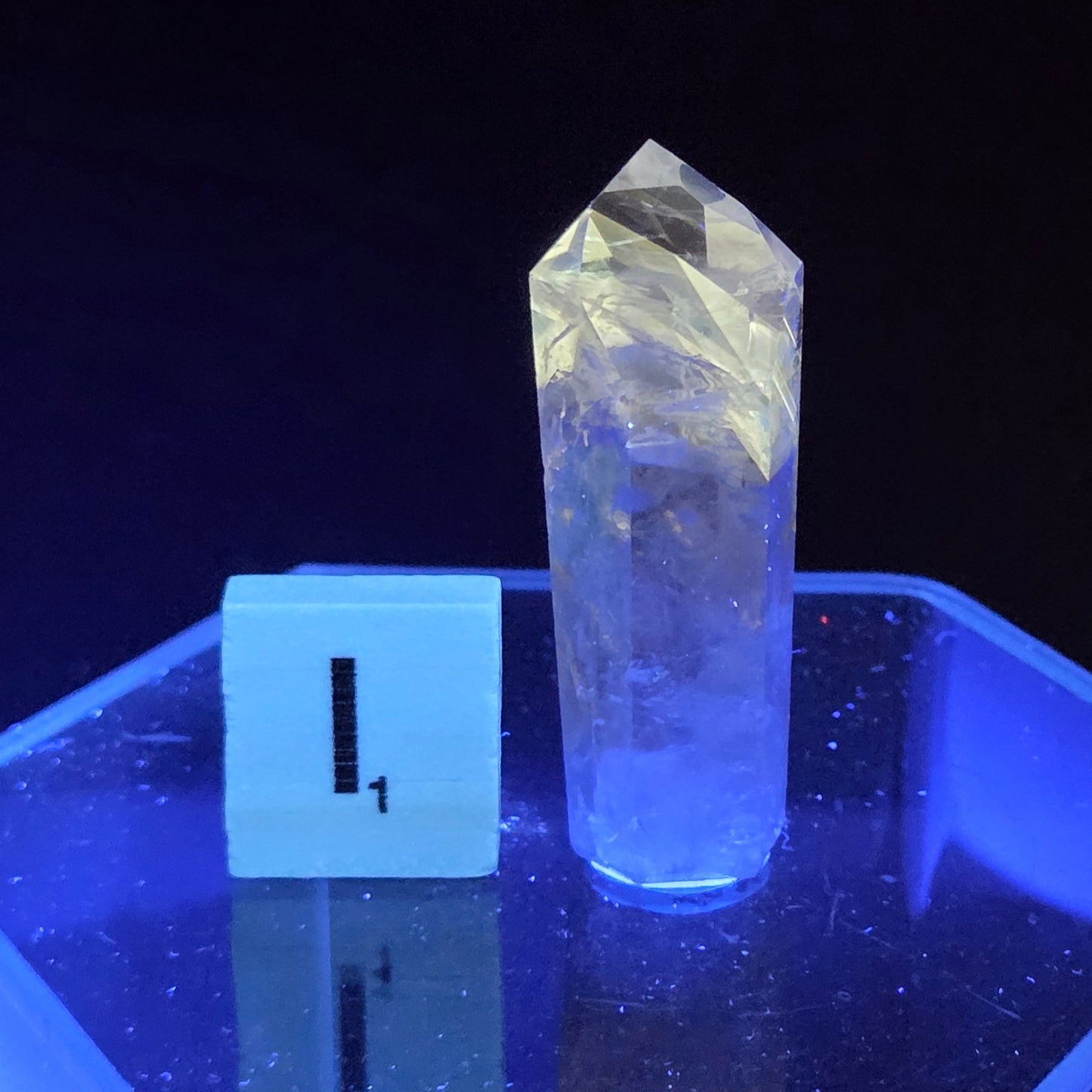 Crystal object on a stand with a dark background