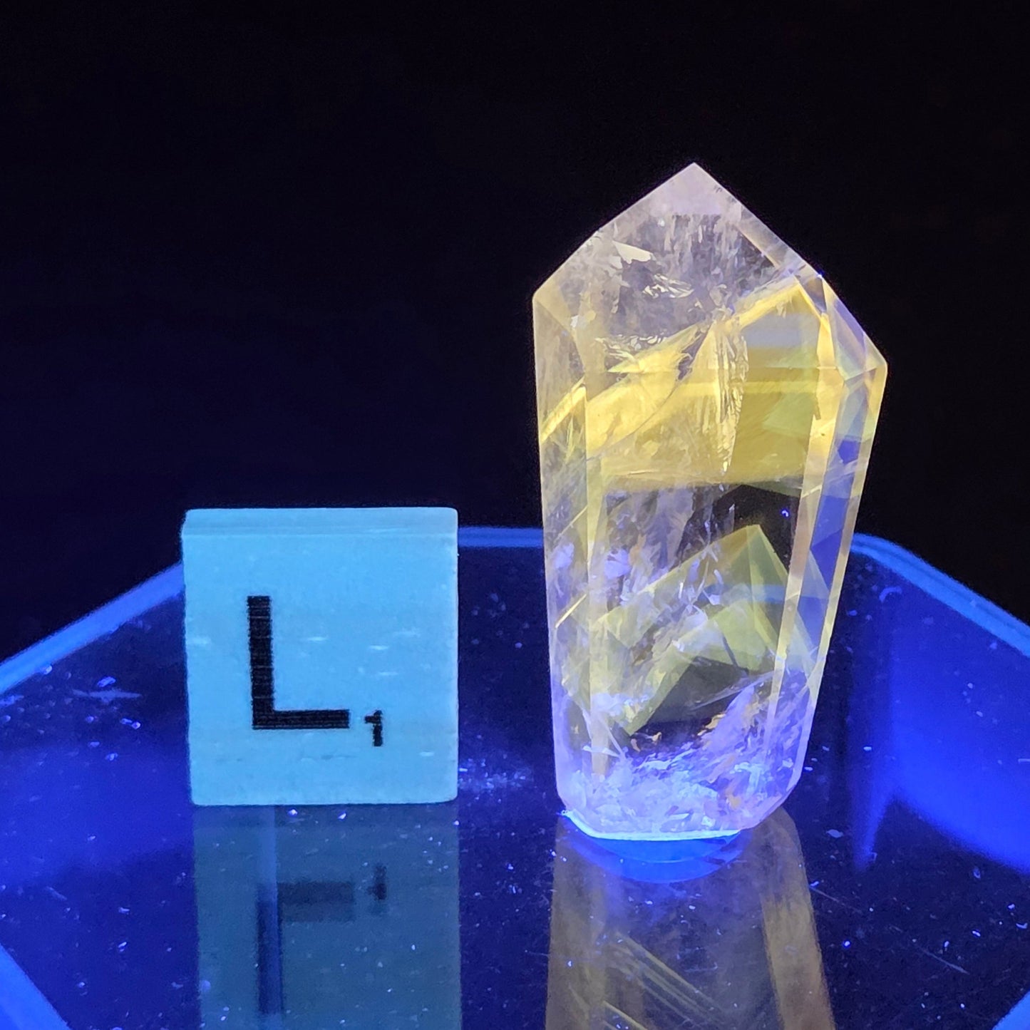 Crystal-like object on a stand with a dark background