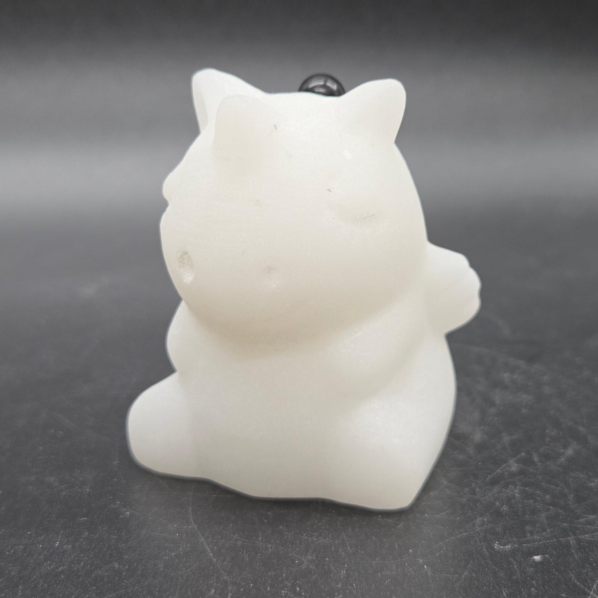 White unicorn-shaped object on a dark surface