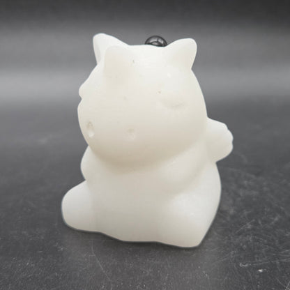 White unicorn-shaped object on a dark surface