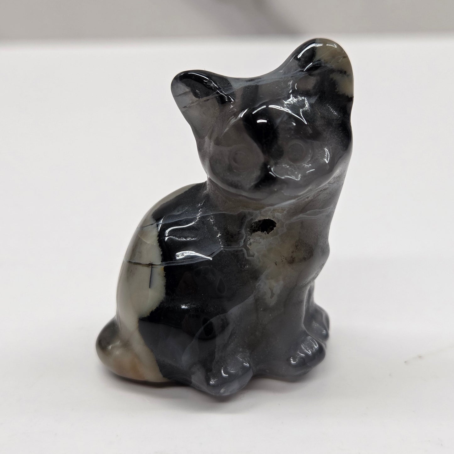 Stone cat carving on a white background