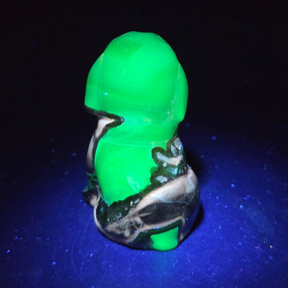 Stone dog carving under a UV lighting on a dark background
