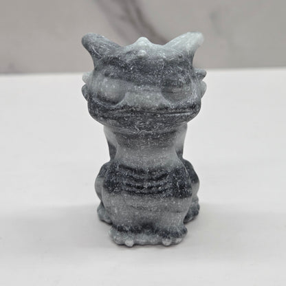 Grey striped dragon carving on a white background