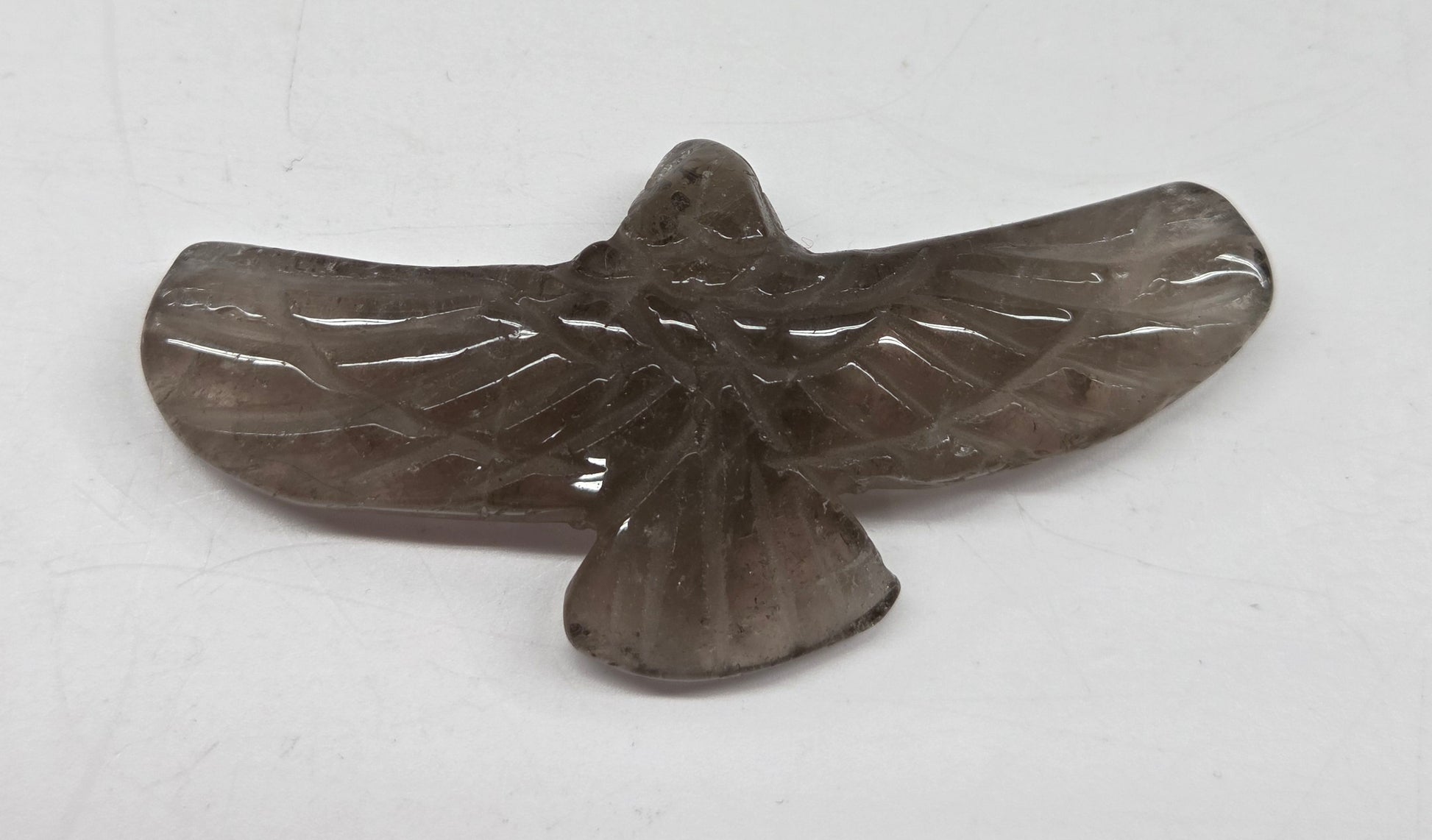 Smoky Quartz eagle carving on a white background