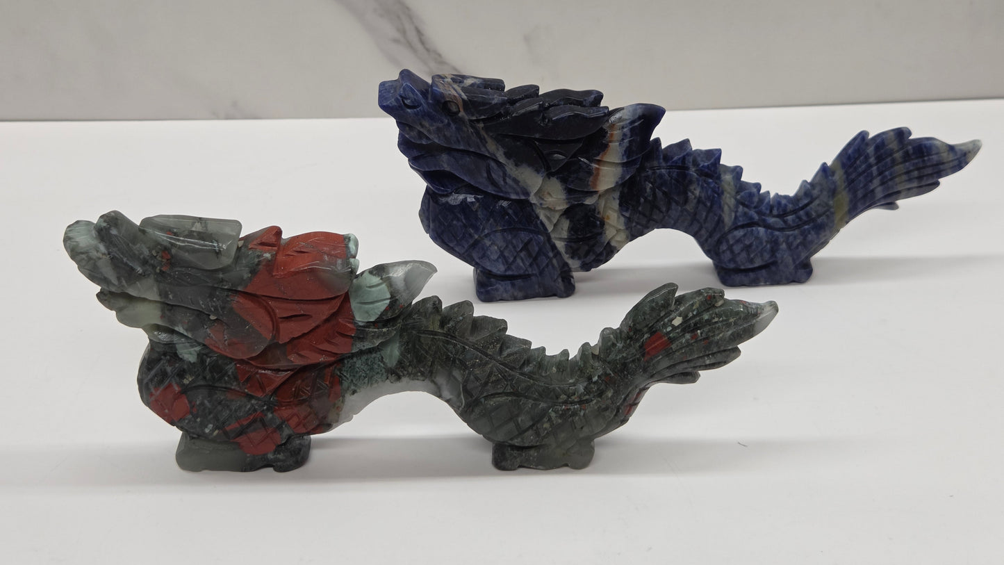 chinese dragon carvings in blue and grey and red colors on a neutral background