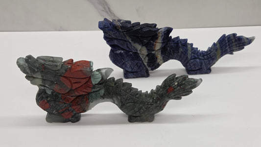 chinese dragon carvings in blue and grey and red colors on a neutral background