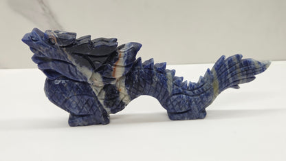 Blue and black chinese dragon carving on a white background