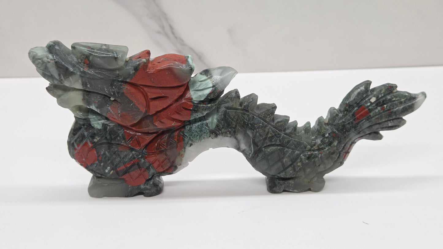 Grey and red chinese dragon carving on a white background