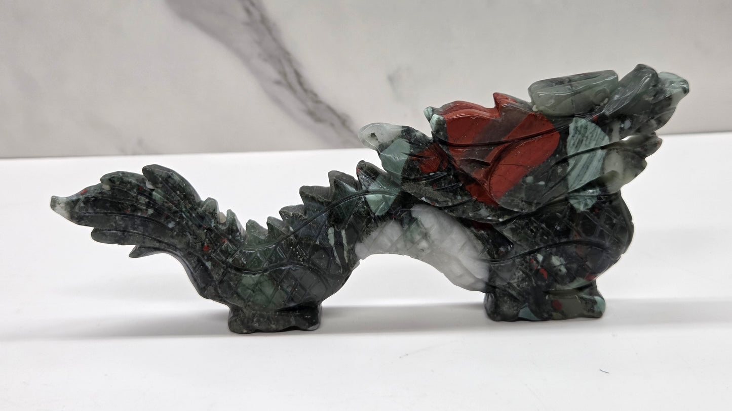 Grey and red chinese dragon carving on a white background