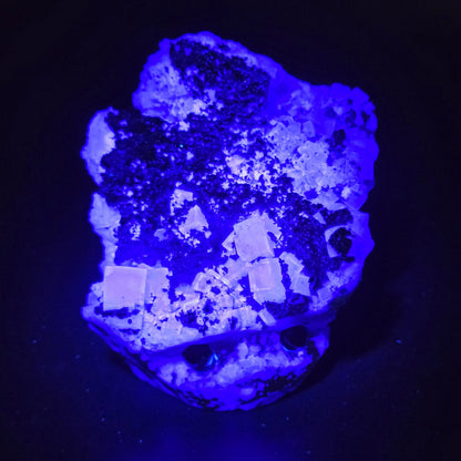 fluorite figurine with black eyes under UV light