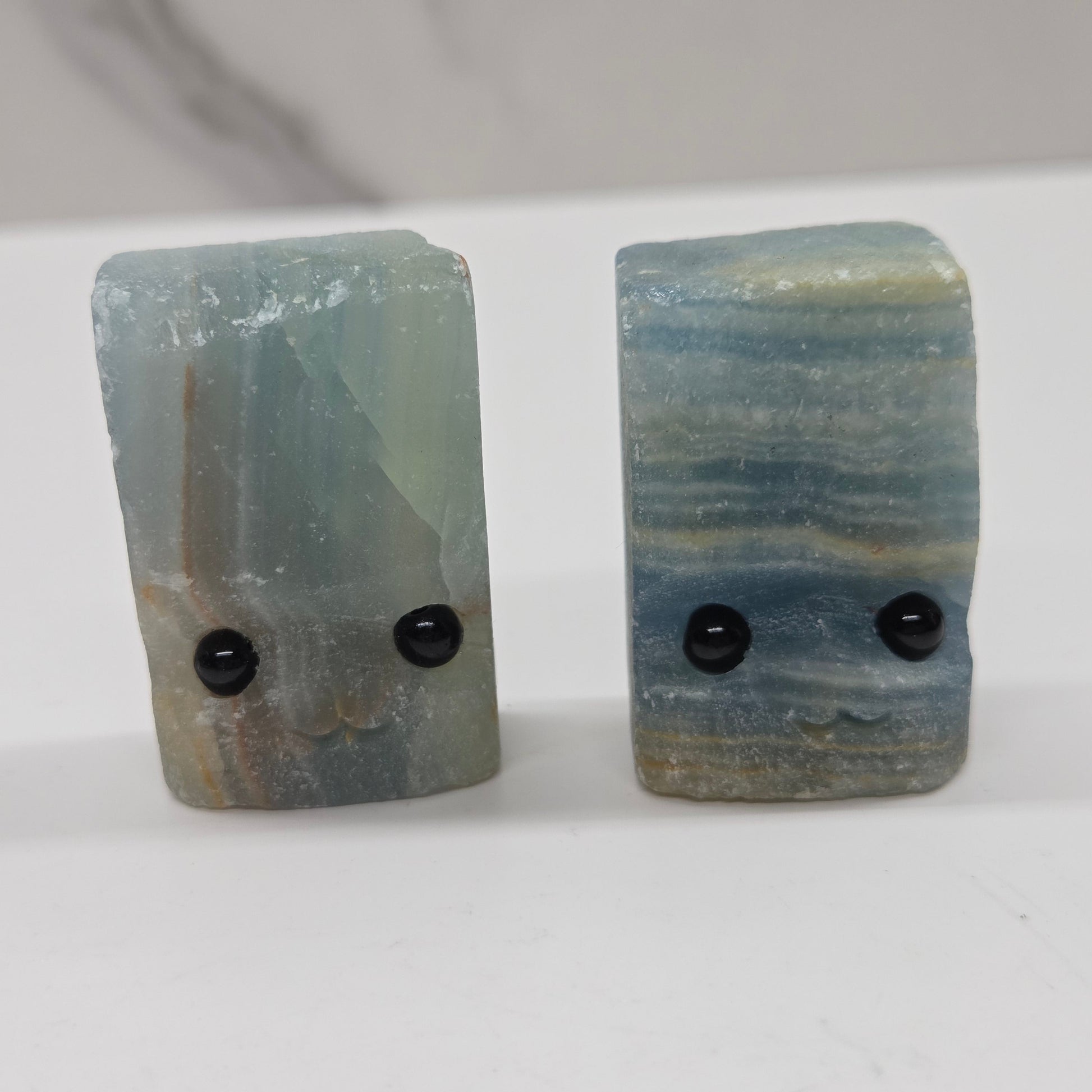 Blue Onyx with eyes and a mouth on a white background