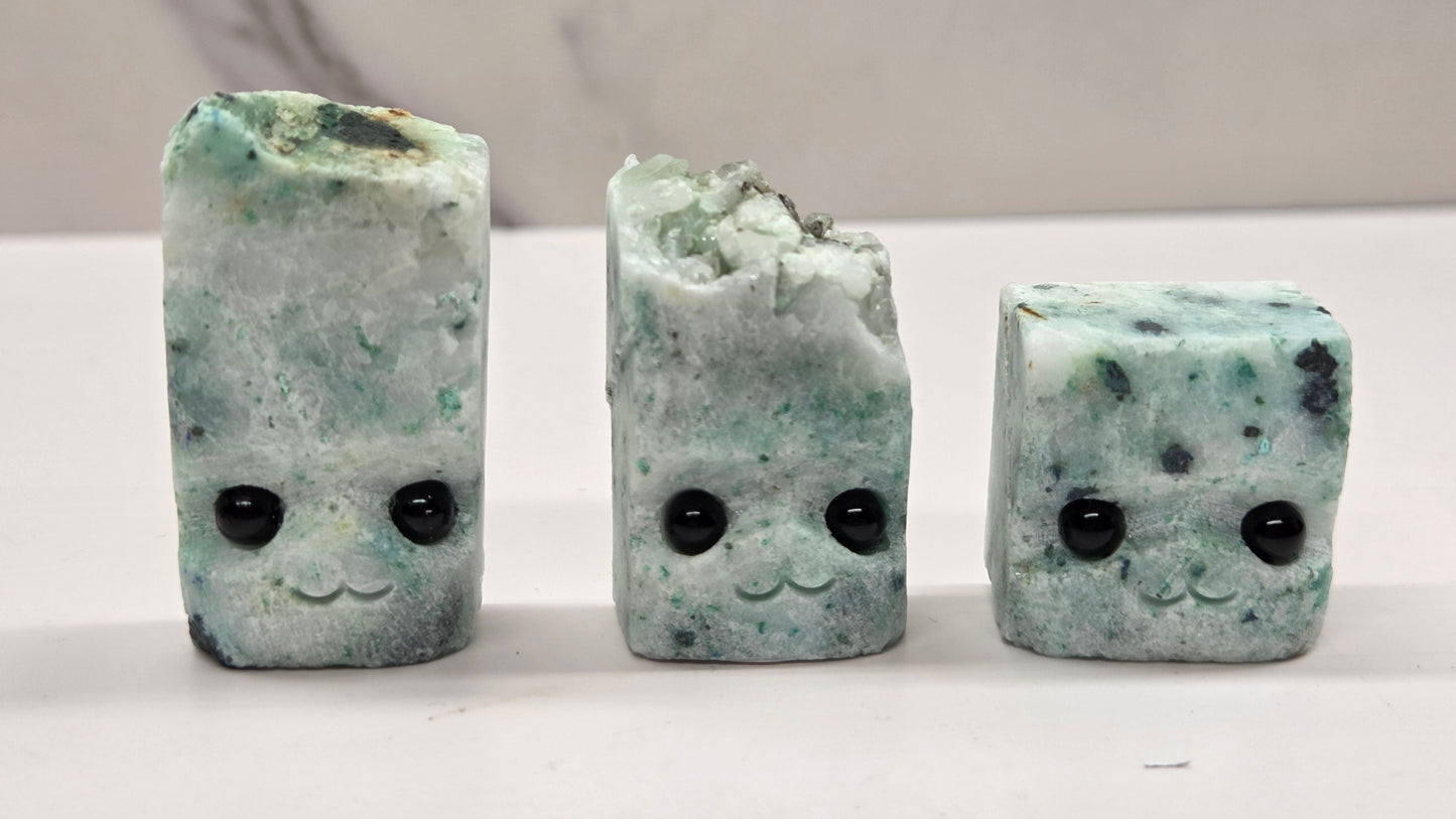 Phoenix Stone with eyes and a mouth on a white background