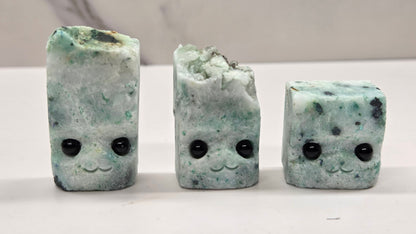 Phoenix Stone with eyes and a mouth on a white background