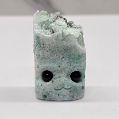 Phoenix Stone with eyes and a mouth on a white background