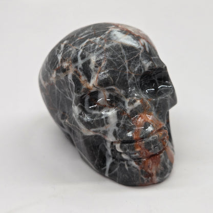 Carved stone skull on a white surface