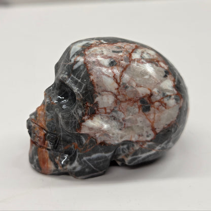 Decorative stone skull on a white surface