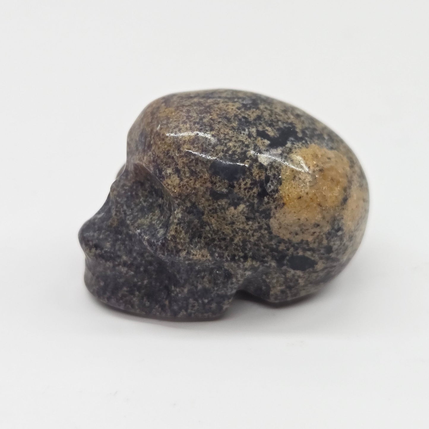 Small stone skull on a white background