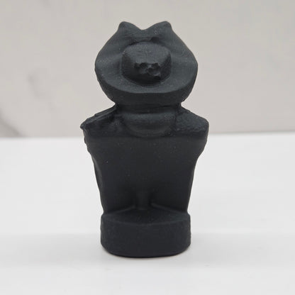 Black bust sculpture of a figure with a pirate hat on a white background