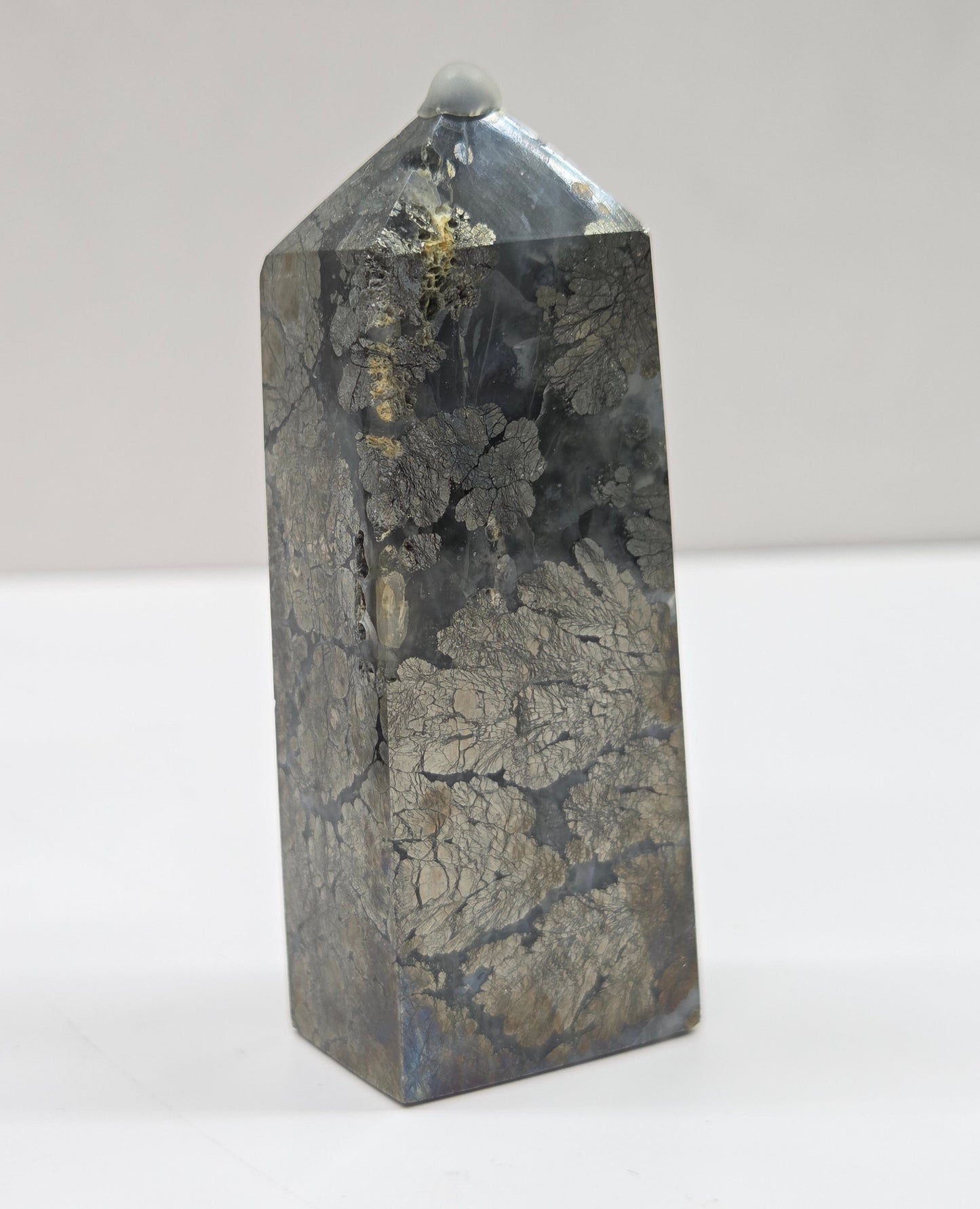 Crystal tower with a cracked surface on a white background