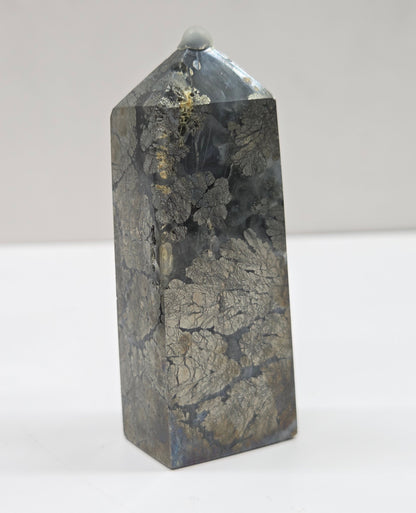 Crystal tower with a cracked surface on a white background