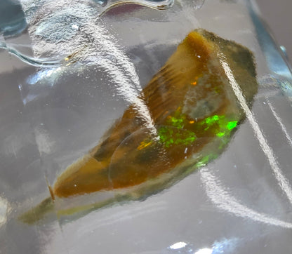 Opal stone on a reflective surface