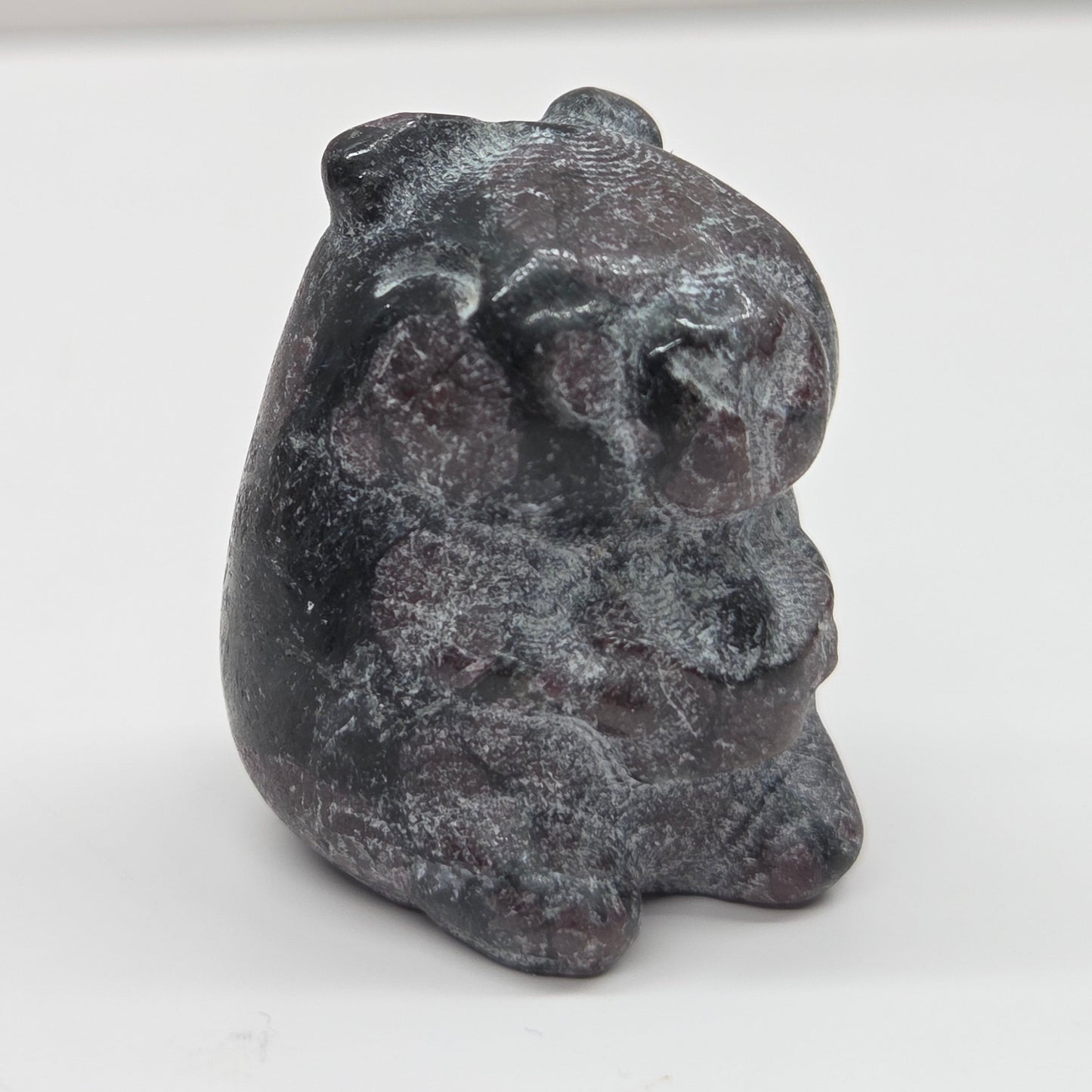 Small stone capybara figurine on a white background
