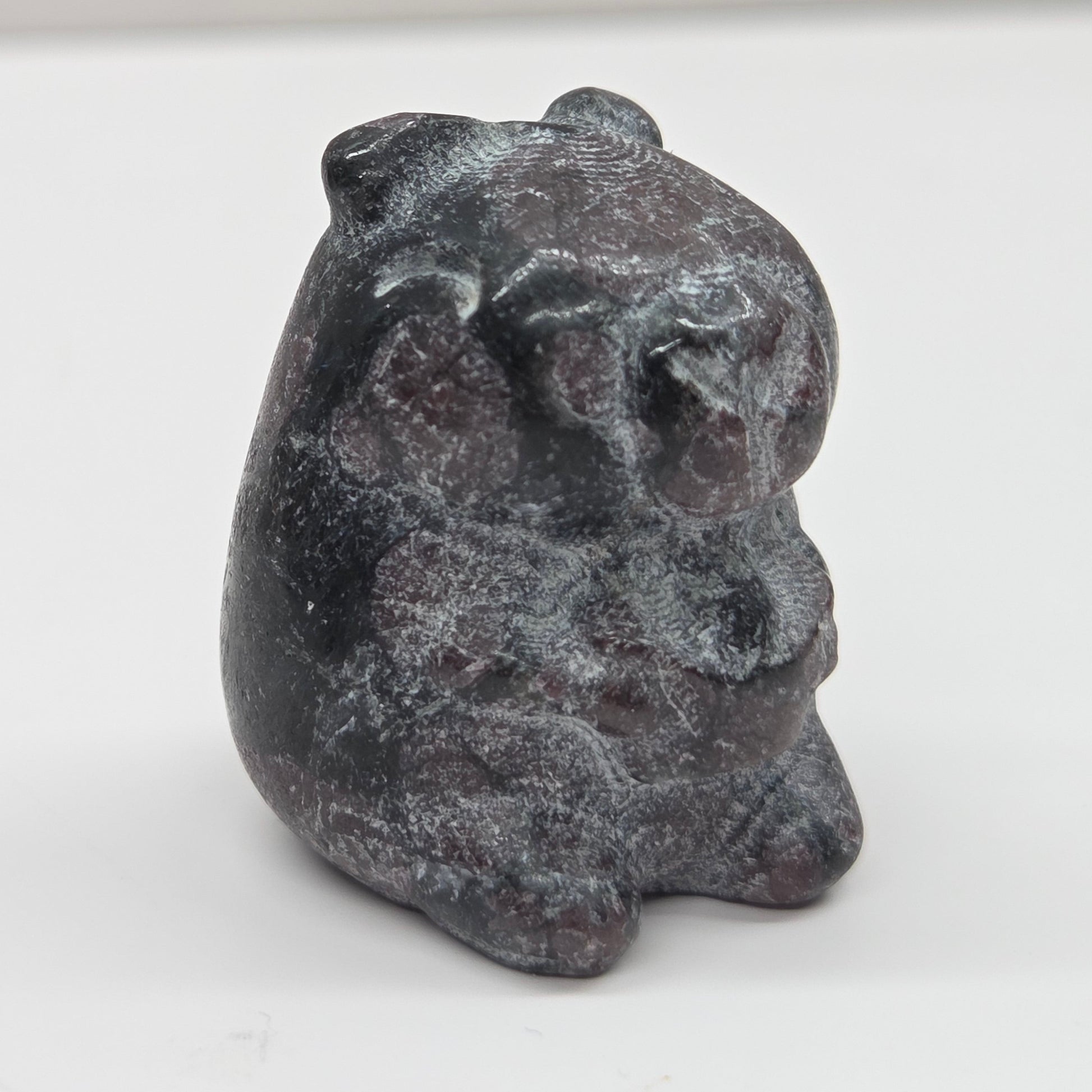 Small stone capybara figurine on a white background