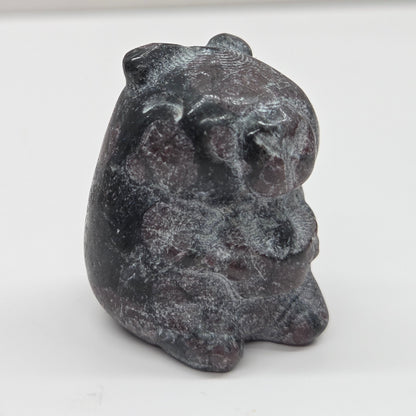 Small stone capybara figurine on a white background
