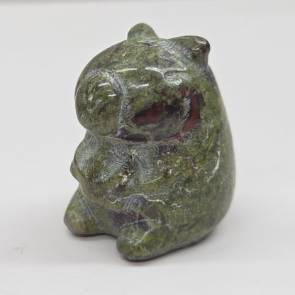 Small stone capybara figurine on a white background