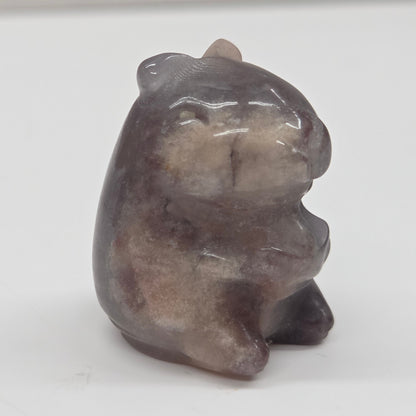 Small stone capybara figurine on a white background
