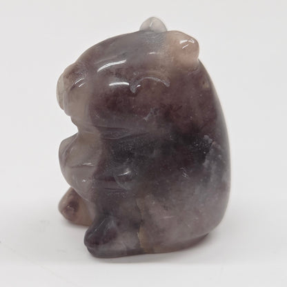 Small stone capybara figurine on a white background