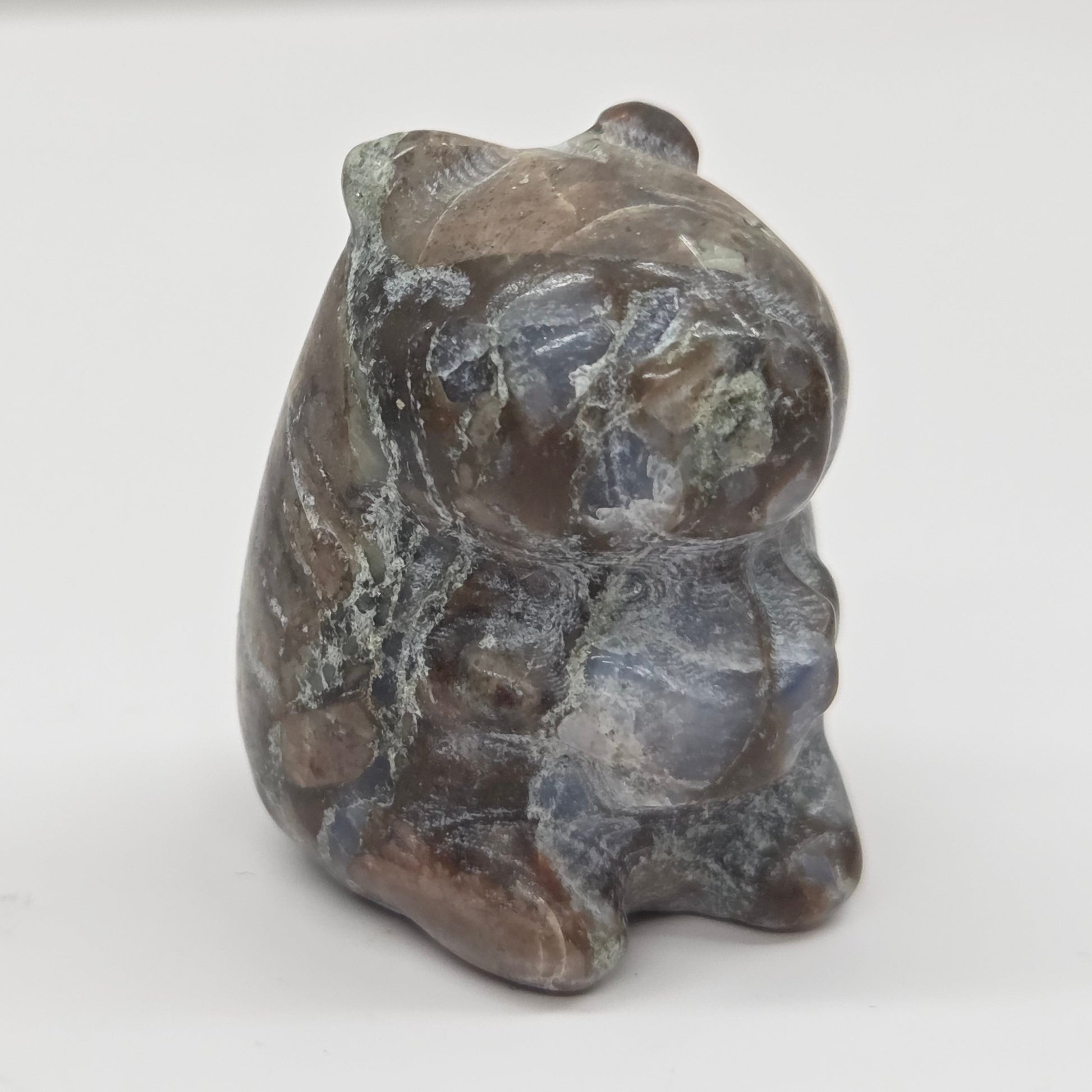Small stone capybara figurine on a white background