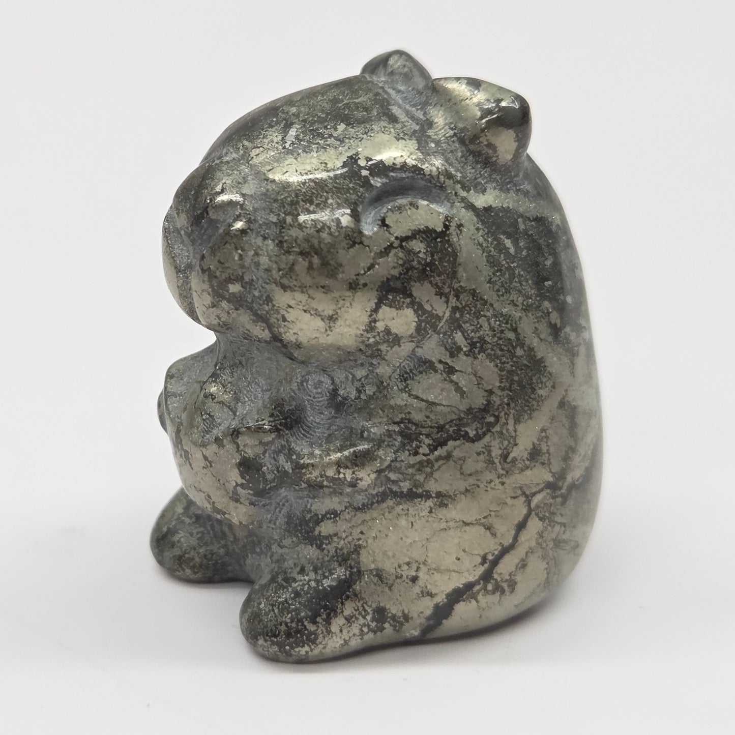 Small stone capybara figurine on a white background