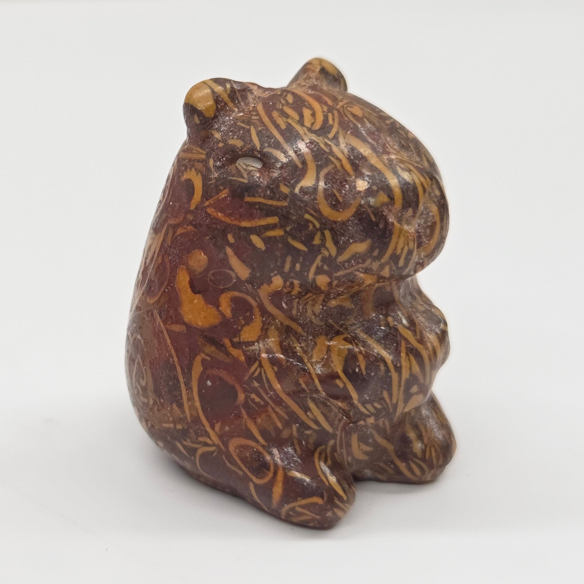 Small stone capybara figurine on a white background