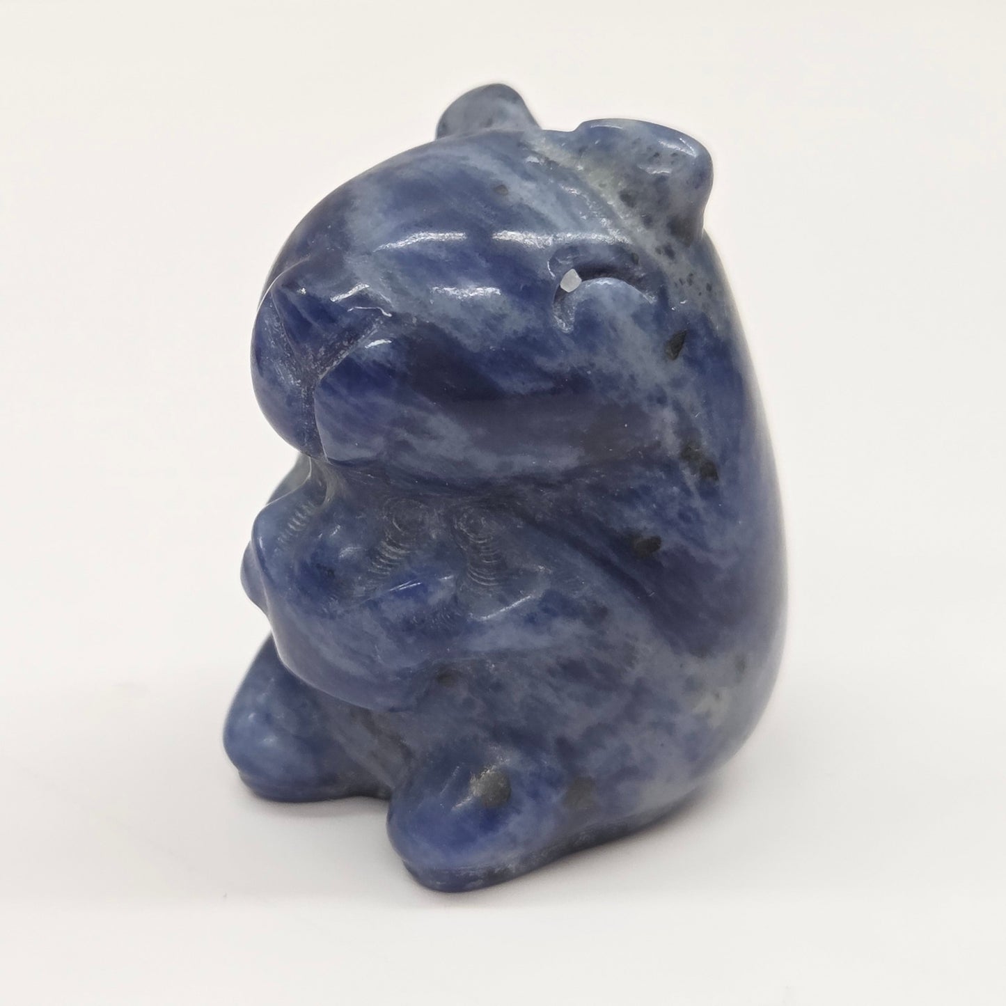 Small stone capybara figurine on a white background