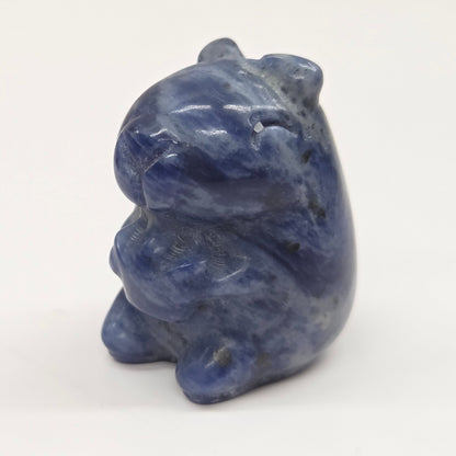 Small stone capybara figurine on a white background