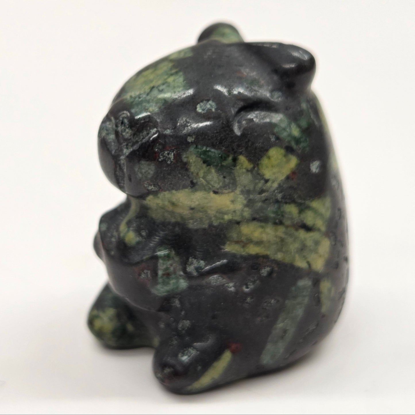Small stone capybara figurine on a white background