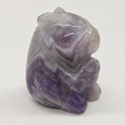 Small stone capybara figurine on a white background