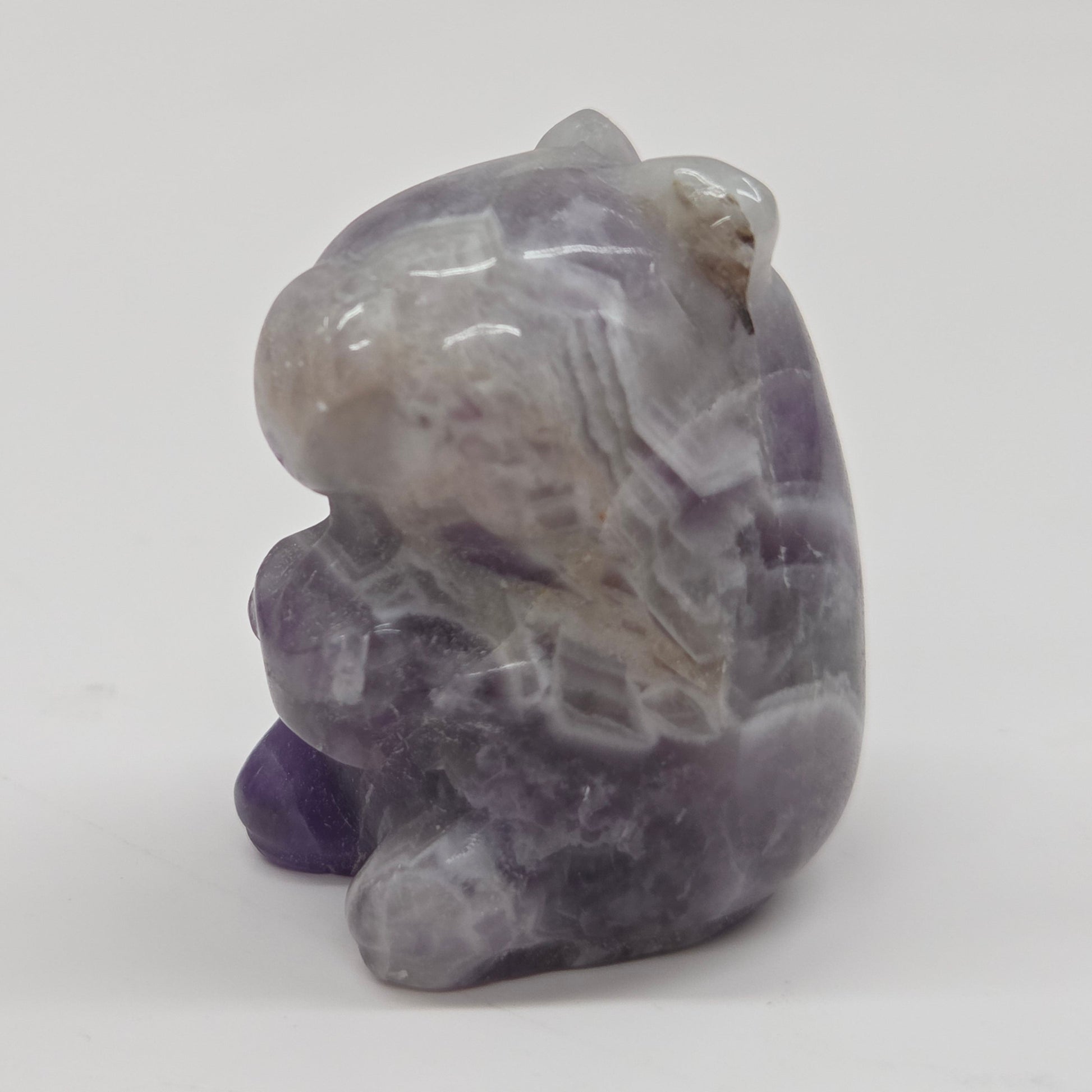 Small stone capybara figurine on a white background