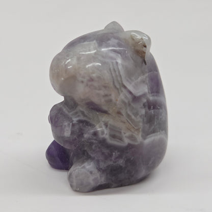 Small stone capybara figurine on a white background