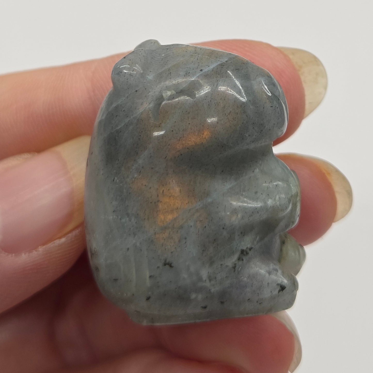 Small stone capybara figurine on a white background
