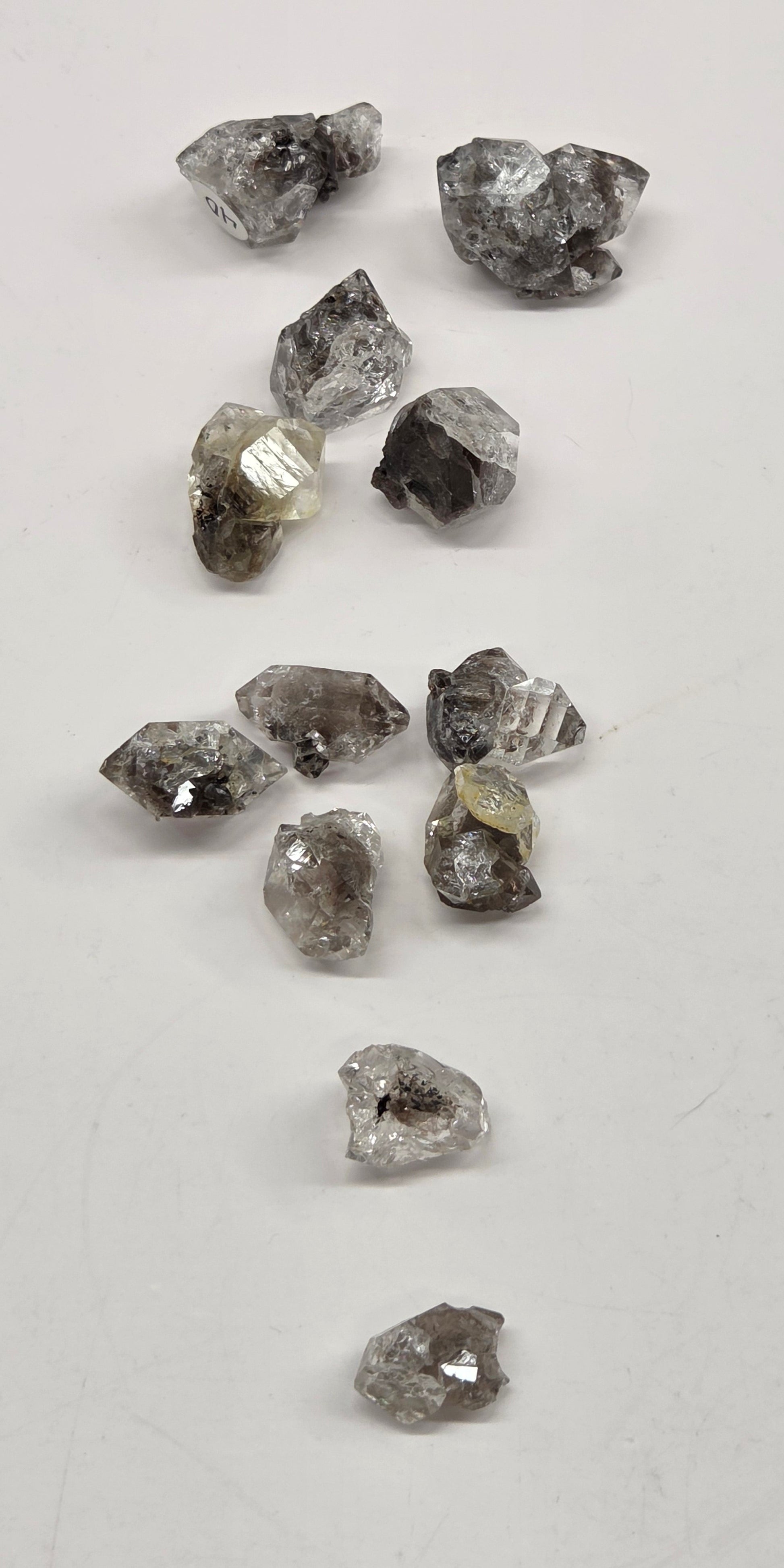 Collection of rough diamonds on a light gray background