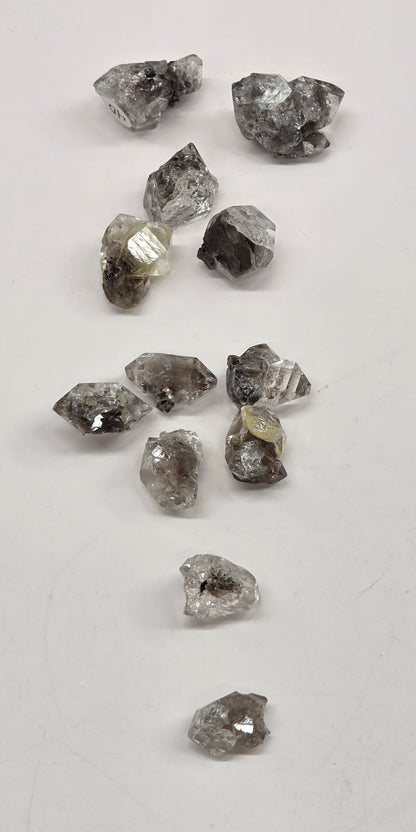 Collection of rough diamonds on a light gray background