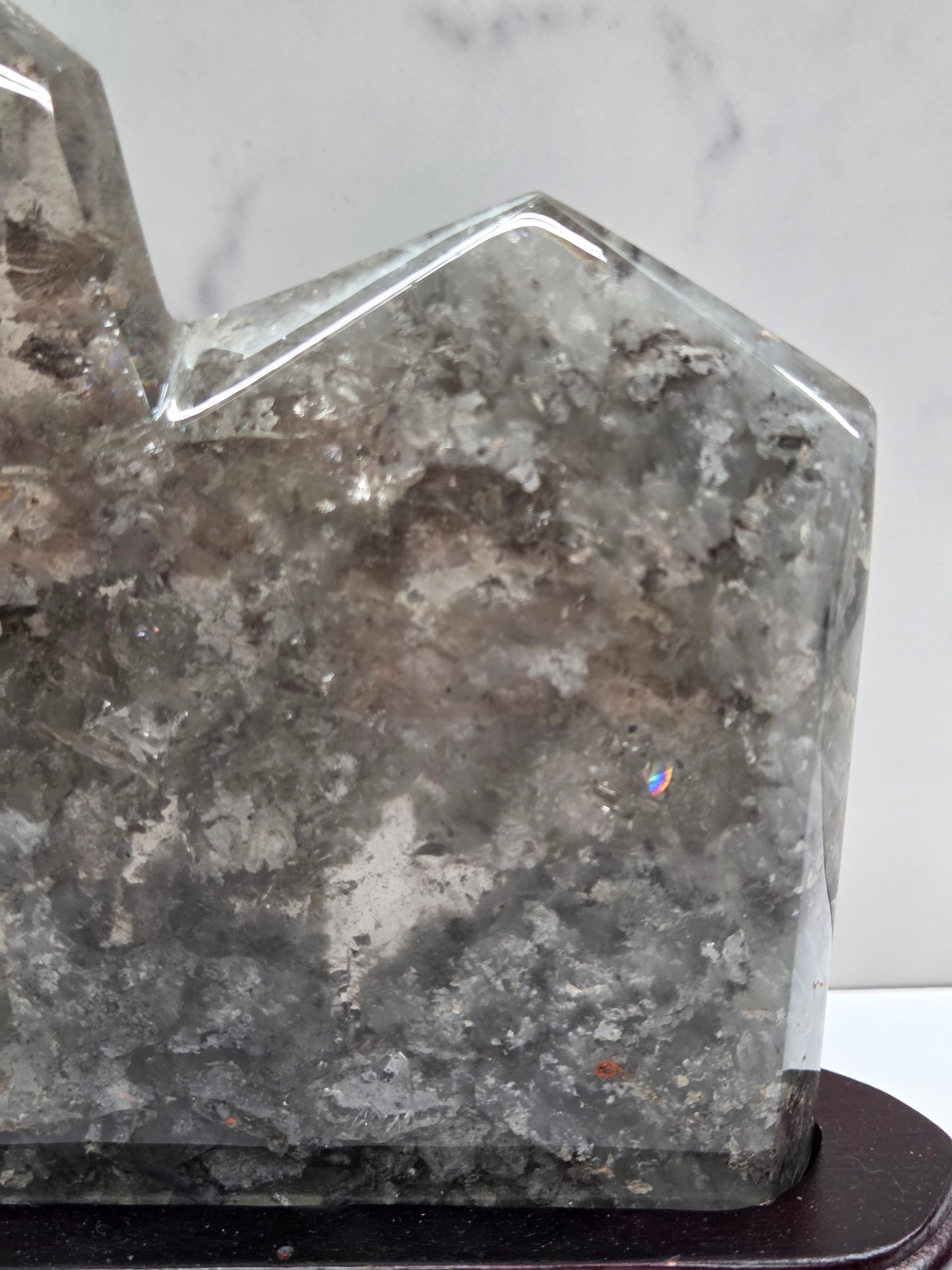 Star-shaped crystal on a stand with a marble background