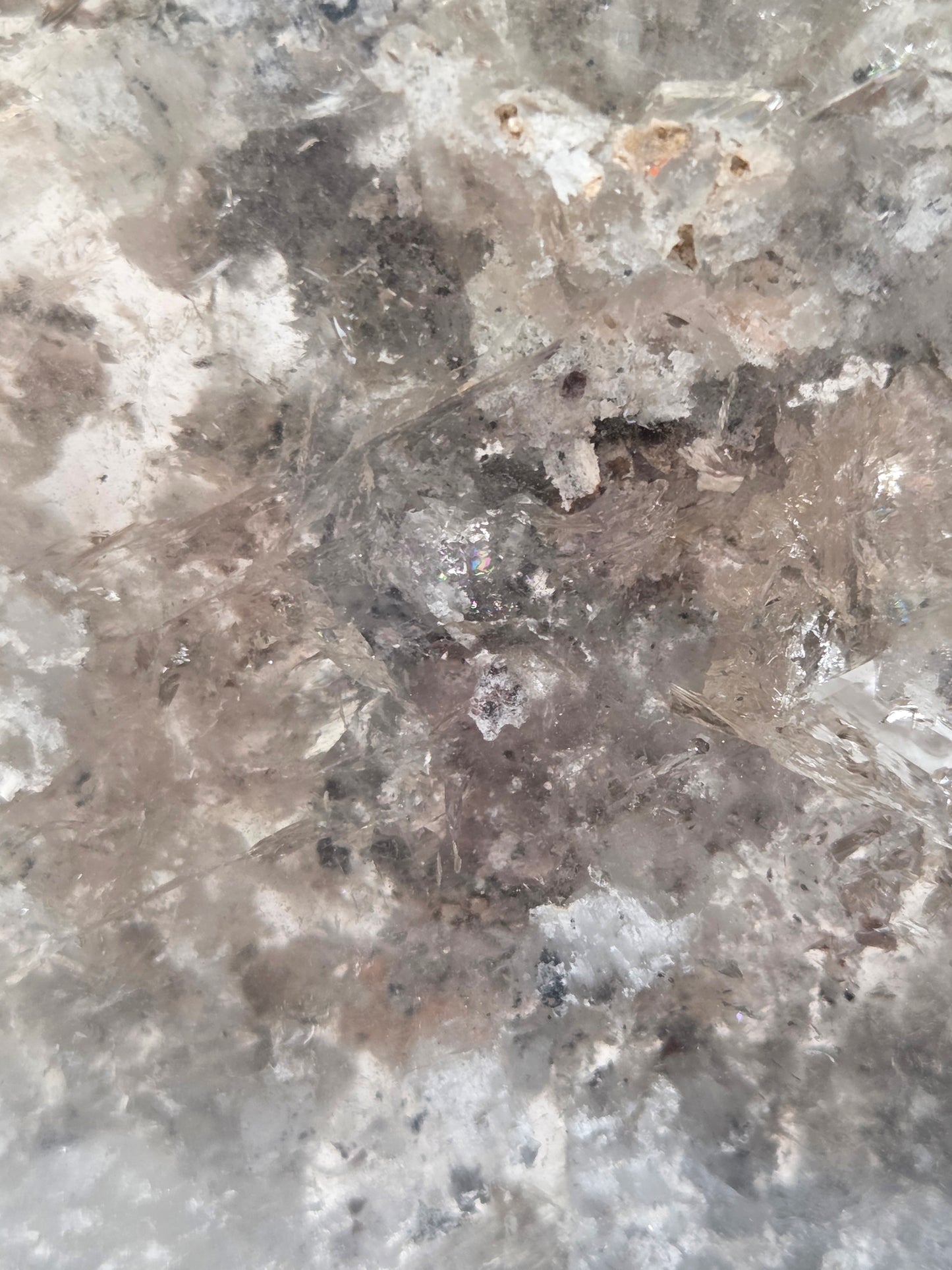Close-up of a crystal formation with a star-like shape on a gray background