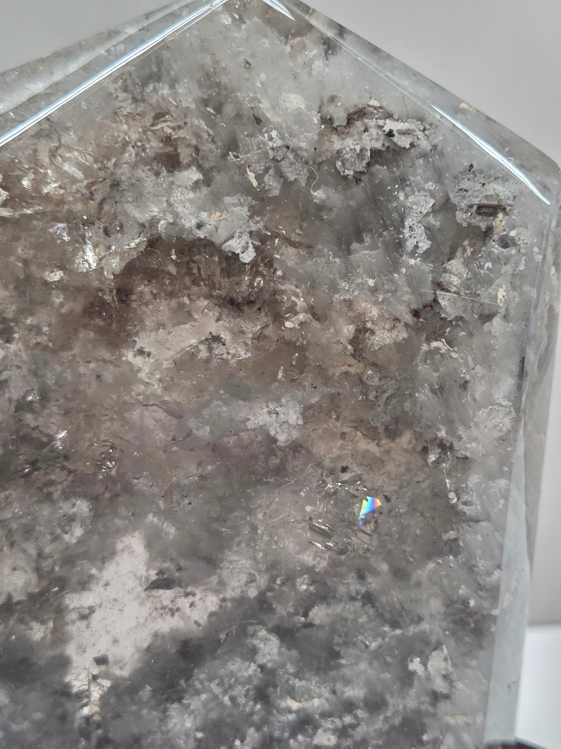 Close-up of a crystal with visible inclusions on a white background