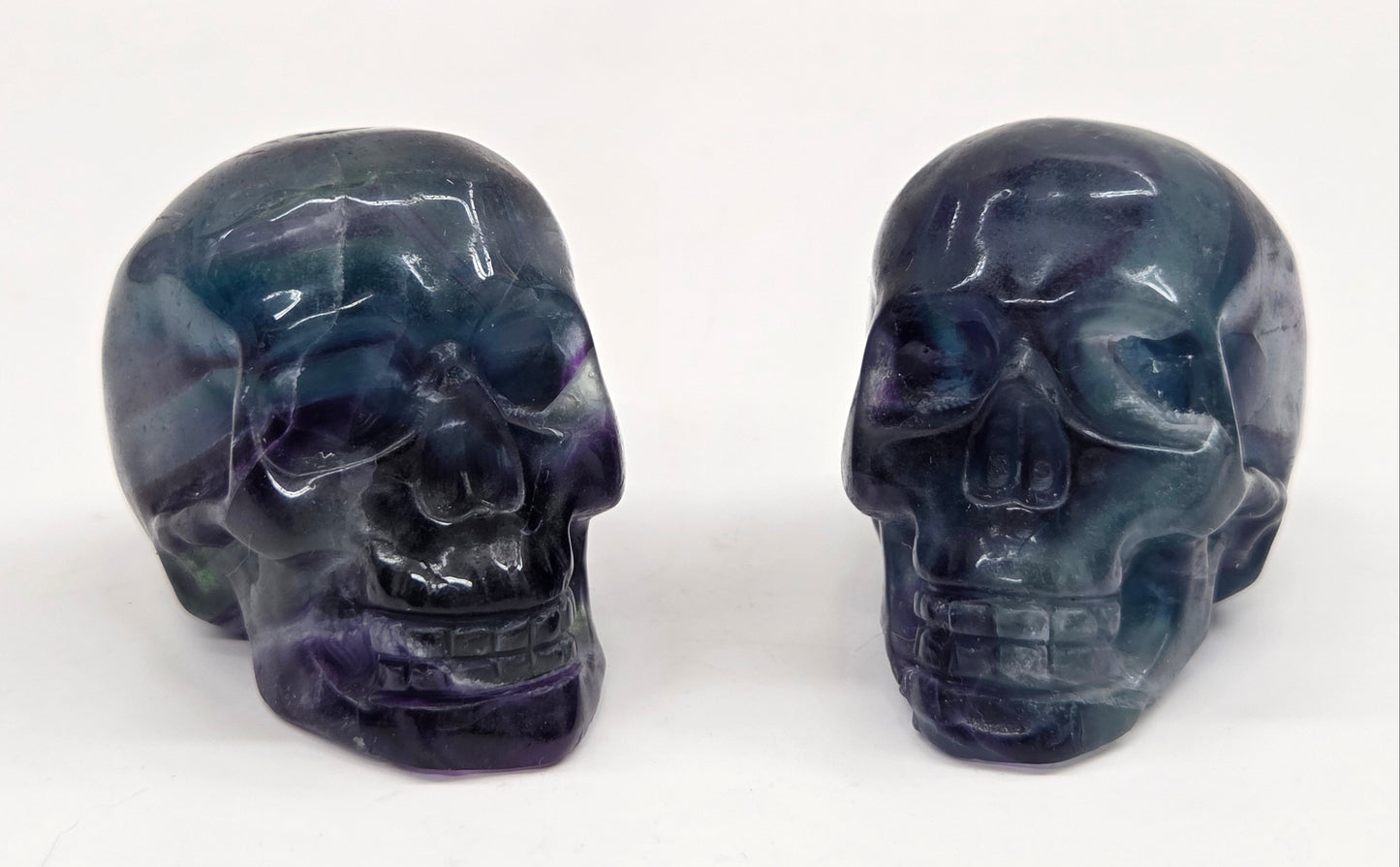 Fluorite skull carvings on a white background