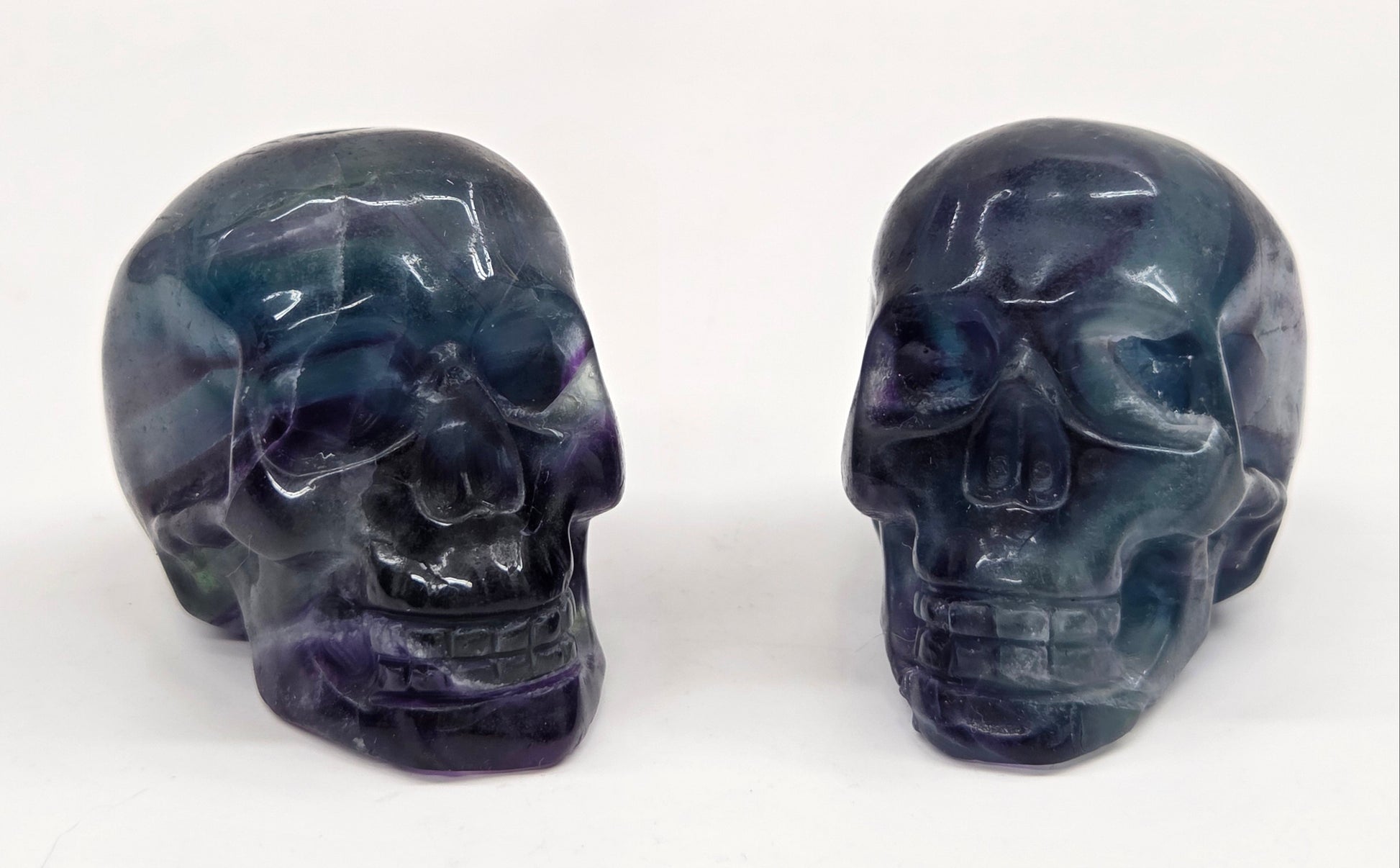 Fluorite skull carvings on a white background